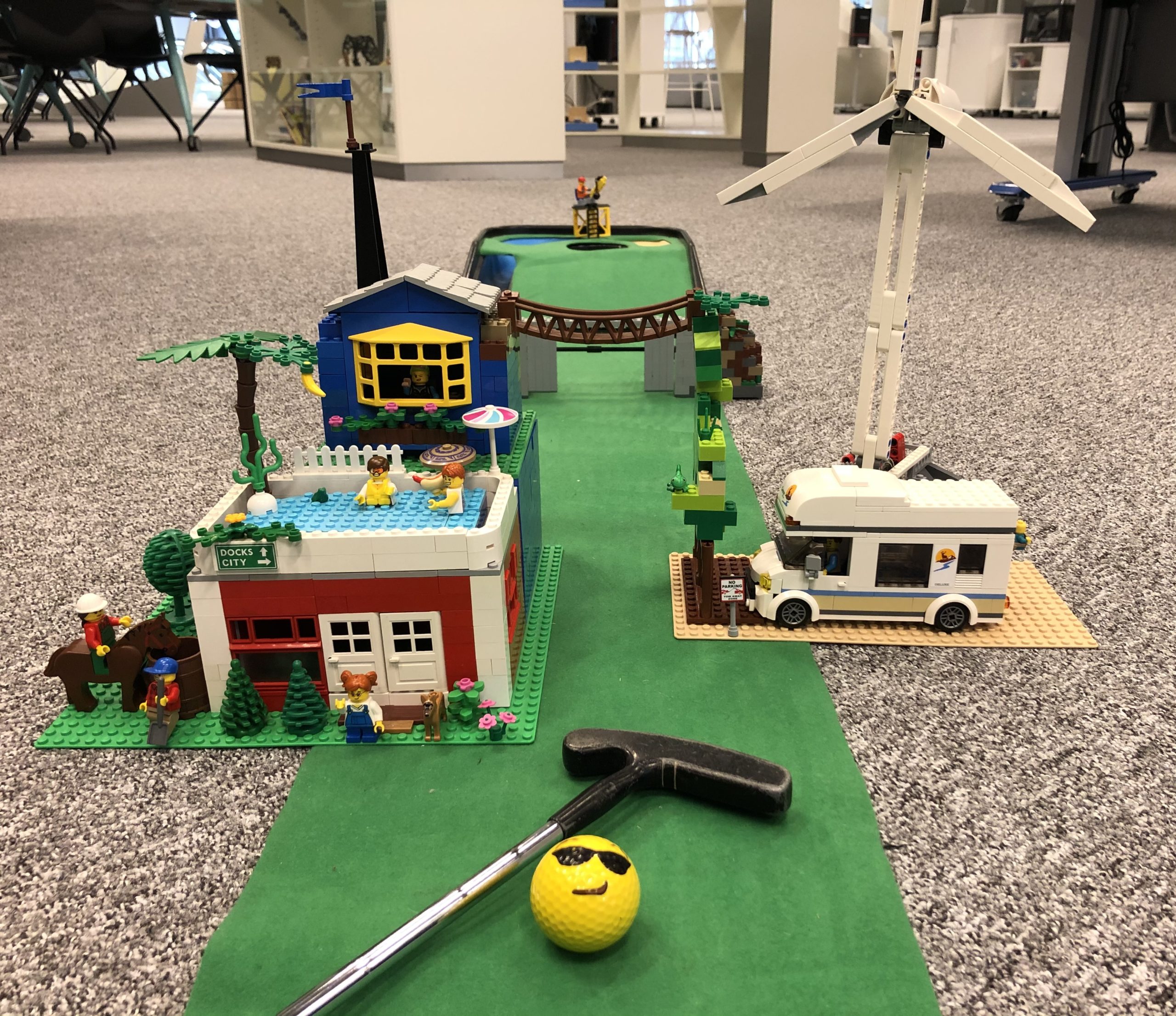 Minigolfbana byggd i LEGO. Banan innehåller två hus, en husbil, ett vindkraftverkt och en hängbro.
